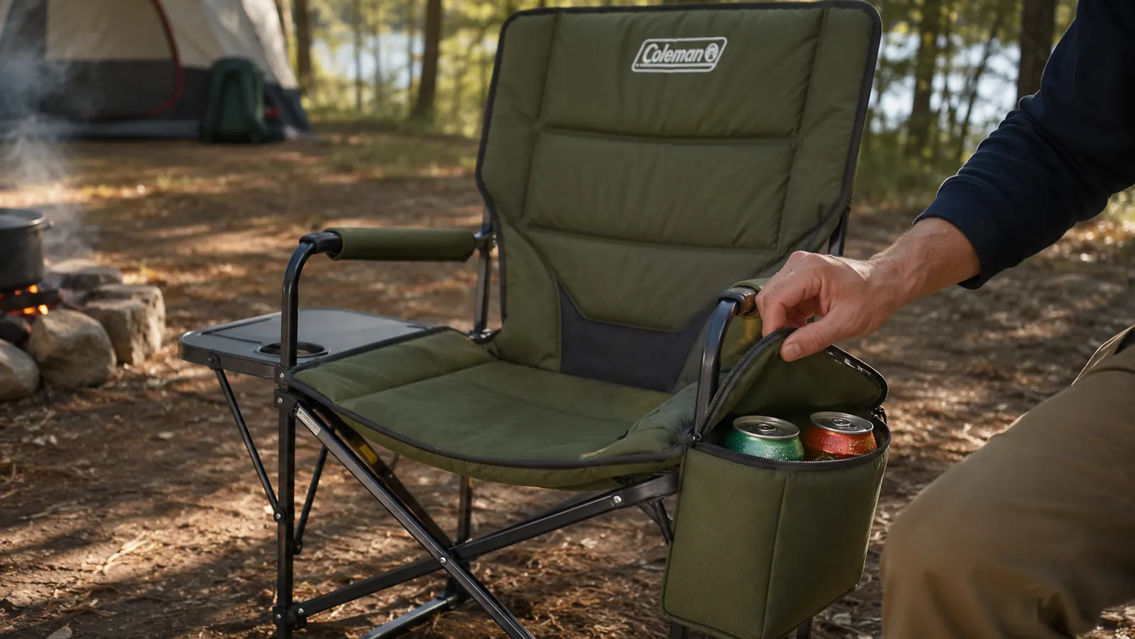 Close-up of the Coleman camping chair cooler arm pocket open, showing two cans inside with visible condensation on a warm day