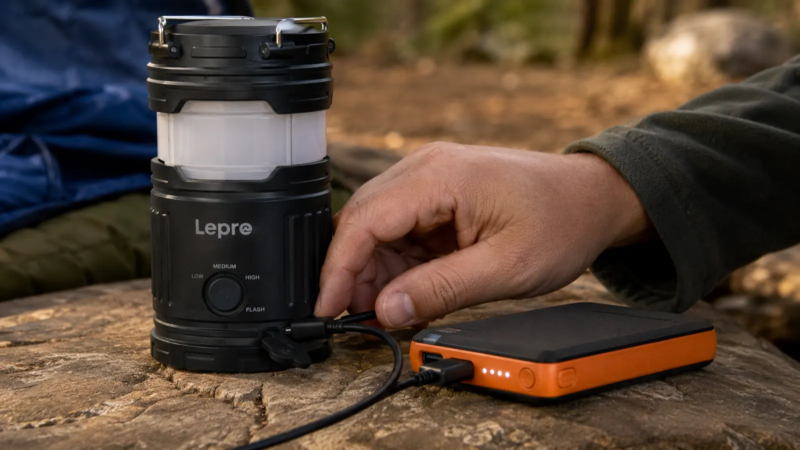 Close-up of the Lepro lantern USB charging port with a cable plugged in next to a power bank