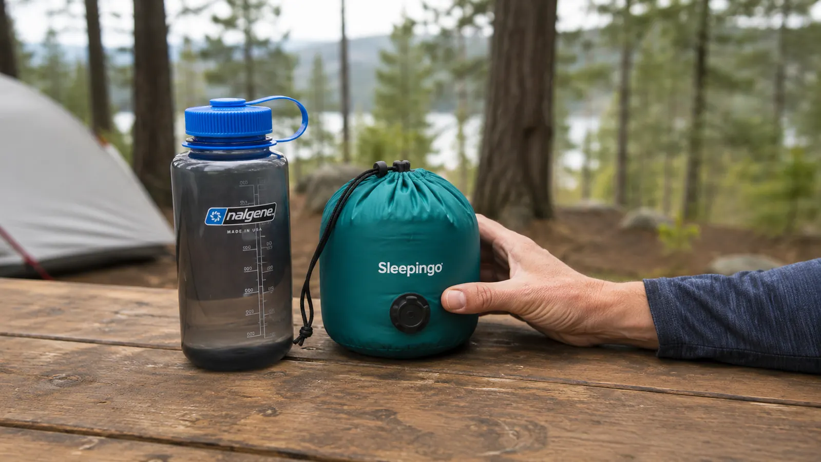 Rolled and packed Sleepingo sleeping pad next to a water bottle for size comparison
